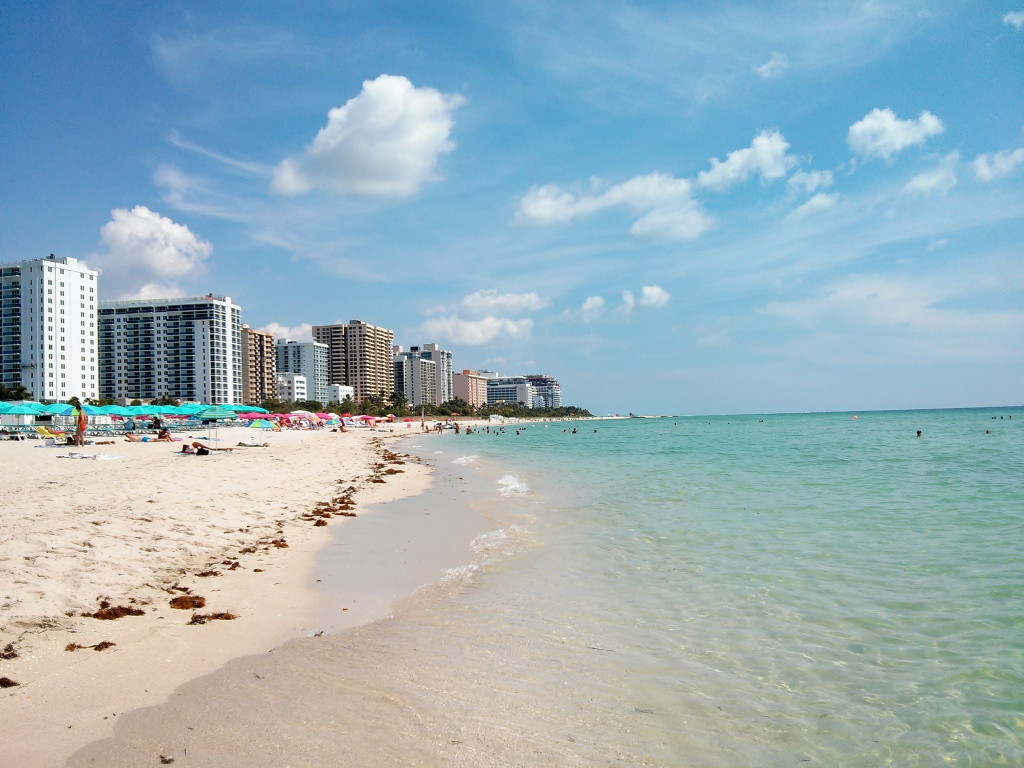 Sunny day in South Beach, Miami with ocean and hotels.